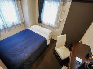 Ένα ή περισσότερα κρεβάτια σε δωμάτιο στο HOTEL LiVEMAX Umeda Doyama