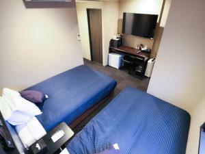 Postel nebo postele na pokoji v ubytování HOTEL LiVEMAX Tokyo-Otsuka Ekimae