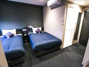 Postel nebo postele na pokoji v ubytování HOTEL LiVEMAX Tokyo-Otsuka Ekimae