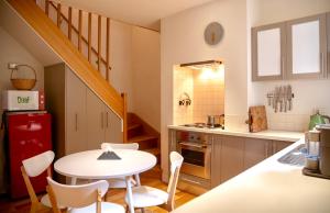 a kitchen with a table and a small table and chairs at Lotus Gogh Apartment in Hobart