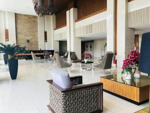 a lobby with chairs and tables in a building at Wind Residences by SMCo in Tagaytay