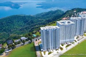 an aerial view of a large building near the water at Wind Residences by SMCo in Tagaytay