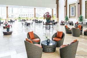a lobby with chairs and tables in a building at Wind Residences by SMCo in Tagaytay