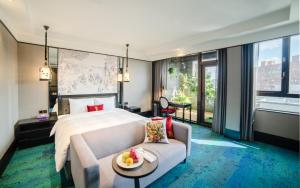 a hotel room with a bed and a couch at Just Palace Hotel in Taipei +62 photos