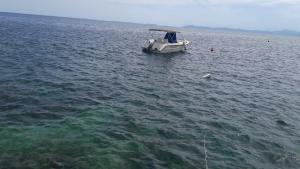 a small boat in the middle of the water at Foissner Apartments in Zavalatica