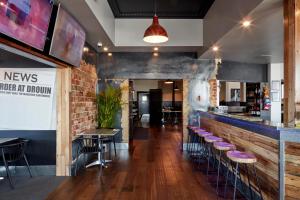 a restaurant with a bar with stools at The Royal Hotel, Drouin in Drouin