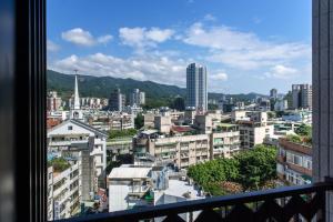 a view of a city from a balcony at Just Palace Hotel in Taipei