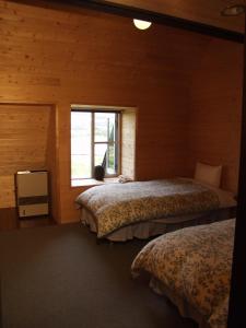 Giường trong phòng chung tại Oyado Raku