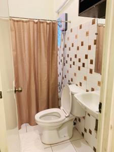 a bathroom with a toilet and a sink at Z Pension in Dumaguete