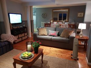 a living room with a couch and a table at Knysna River View in Knysna