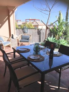 a blue table and chairs on a patio at Casa Bonita Estepona in Estepona