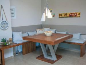 a dining room table with two benches and a bowl on it at Luxury Villas 1 in Synoikismós Panteleímonos