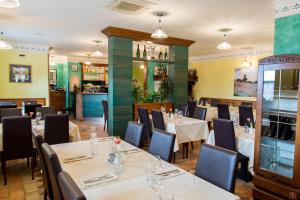 a restaurant with tables and chairs and a bar at Domačija pri Damjanu in Kozina