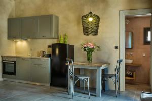 a kitchen with a table and a refrigerator at Villa Daniela - Saint Nikolas Retreat in Faraklata +24 photos
