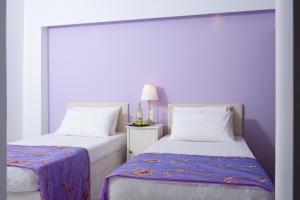 A bed or beds in a room at Primavera Beach Hotel Studios & Apartments