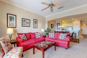 a living room with red couches and a table at 1000 Cinnamon Beach in Palm Coast