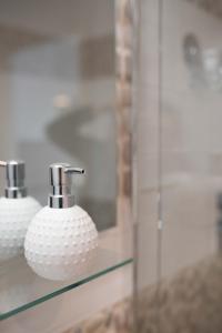 a bathroom with a glass shelf with two toothbrushes at Le Tout à Pied et son parking privé in Étretat +17 photos