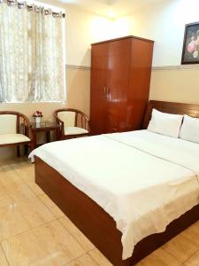 Postel nebo postele na pokoji v ubytování Thanh An Hotel