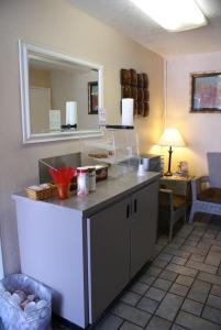 a kitchen with a counter and a mirror in a room at Heritage Inn San Diego in San Diego