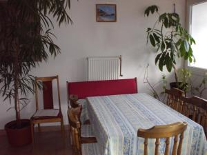 a bedroom with a table and chairs and plants at Heppház in Harkány