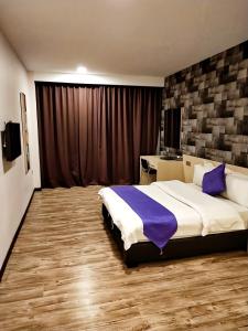 Een bed of bedden in een kamer bij Kidurong Inn