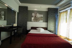 A bed or beds in a room at Minoa Athens Hotel