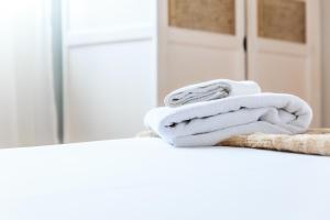 a pile of towels sitting on a counter in a kitchen at Apartamentos Turísticos Architettura Úbeda in Úbeda