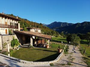 a house on a hill with a grass yard at Agriturismo Al Lambic in Tignale