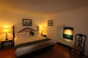 a bedroom with a large bed and a fireplace at Mansion Havre in Mexico City