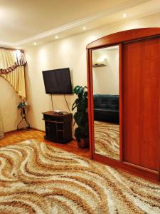a living room with a mirror and a couch at Tiraspol Apartments in Tiraspol