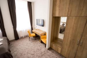 a hotel room with a desk and a mirror at BIVIO hotel in Bratislava