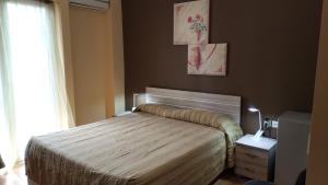 a bedroom with a bed and a window at Ambrosia Suites in Athens +72 photos