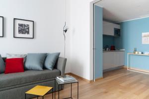 a living room with a couch and a table at Brera Apartments Alla Scala in Milan