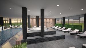 a swimming pool with a fountain in the middle of a building at Hotel Olea in Novalja