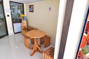 a table and bench in a room with a table and chairs at amenity@22 in Bangkok