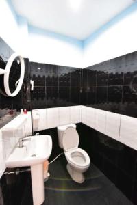 a bathroom with a white toilet and a sink at amenity@22 in Bangkok +17 photos