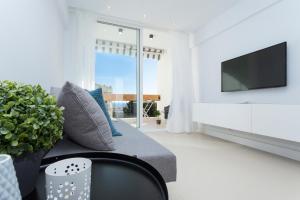 マルベーリャにあるSeaview flat with Sunny Balcony - Central Marbellaのリビングルーム(ソファ、テレビ付)