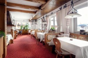 a dining room with white tables and chairs at Chalet Jagdhof in Sankt Johann im Pongau