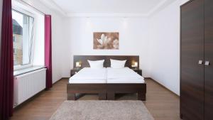 เตียงในห้องที่ Aparthotel - Stadtvilla Premium