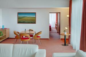 
a living room filled with furniture and a large window at Avanti Hotel in Brno
