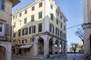 a large building with an arch in a street at Old Town Luxury Suites 'Princess' in Corfu