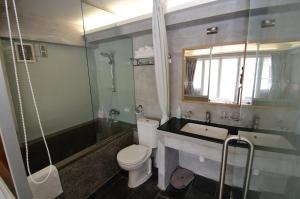 a bathroom with a toilet and a sink and a shower at Espace Elastique B&B with contactless check-in in Hong Kong