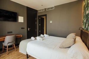 Posteľ alebo postele v izbe v ubytovaní Málaga Premium Hotel