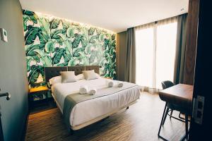 Posteľ alebo postele v izbe v ubytovaní Málaga Premium Hotel