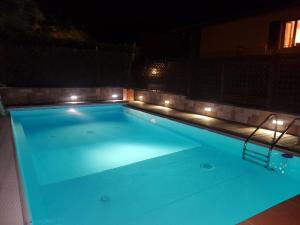a swimming pool at night with lights on it at Casa Camilla in Polpenazze del Garda