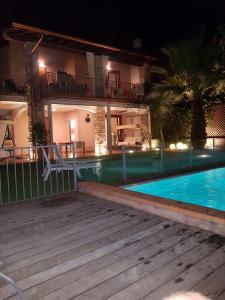 a swimming pool in front of a house at night at Casa Camilla in Polpenazze del Garda
