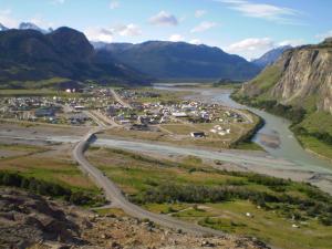 an aerial view of a small town next to a river at Confin Patagonico in El Chalten
