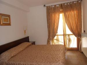Postel nebo postele na pokoji v ubytování Hotel Vitalba