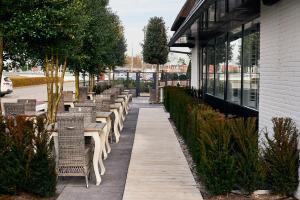 a row of tables and chairs outside of a building at Hotel Heer Hugo in Heerhugowaard