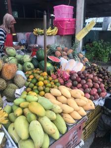 a display of fruits and vegetables in a market at Pixels Condo Unit 261 in Panwa Beach
